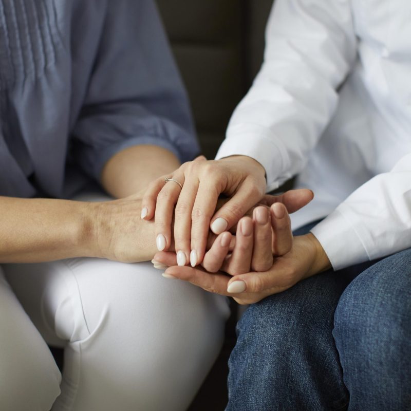 covid-recovery-center-female-doctor-holding-elder-patient-s-hands-scaled.jpg