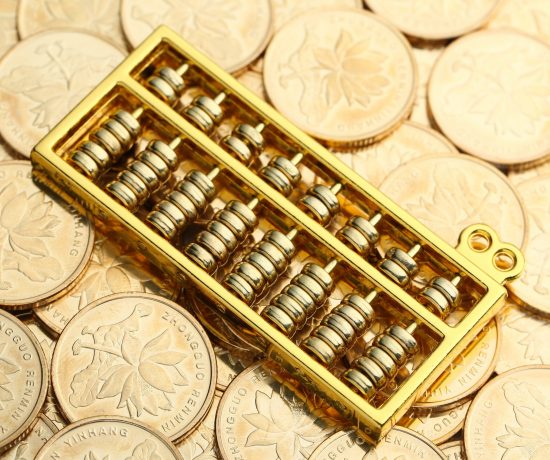 golden-abacus-with-chinese-rmb-gold-coins-as-background-scaled.jpg